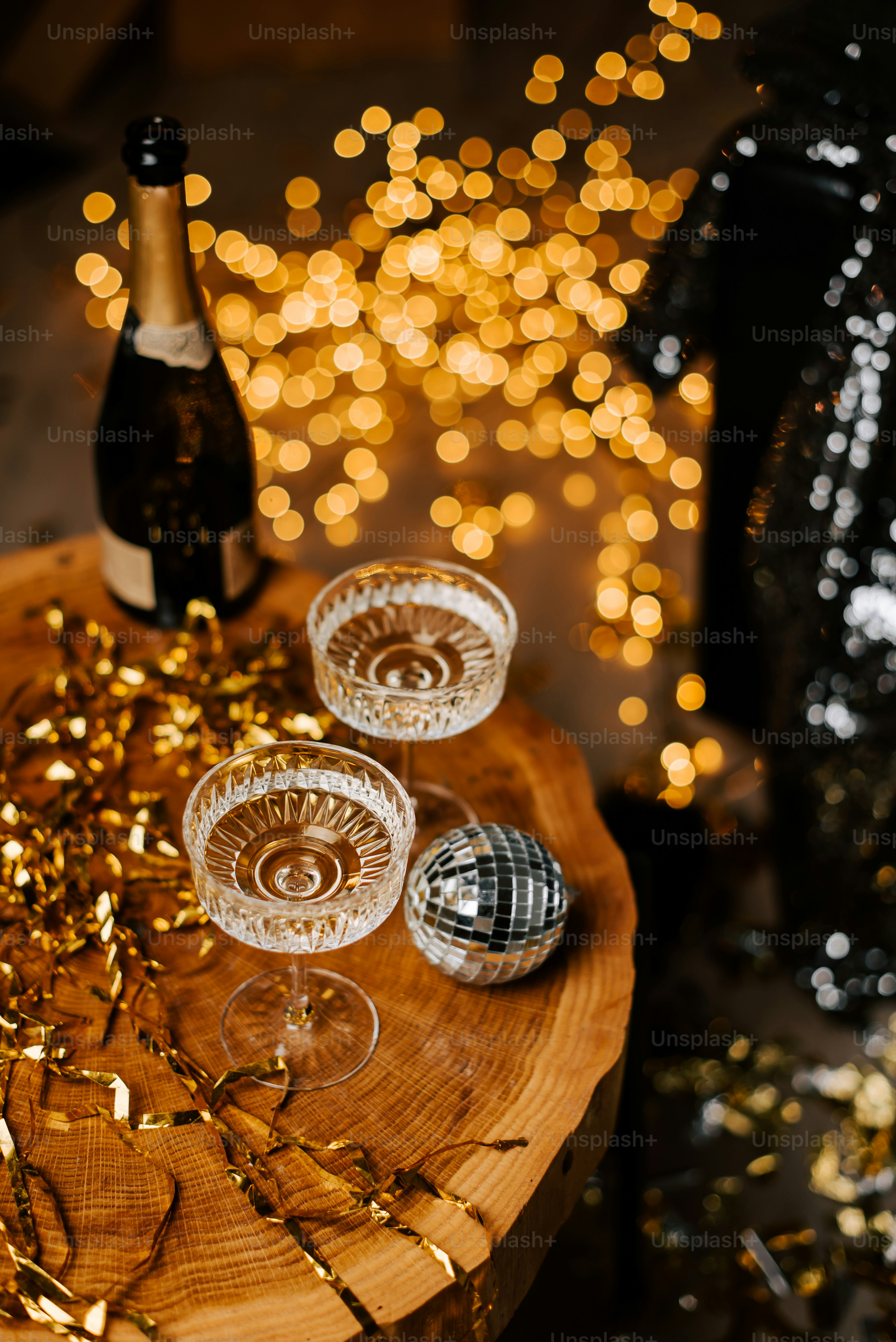 a wooden table topped with wine glasses and a bottle
