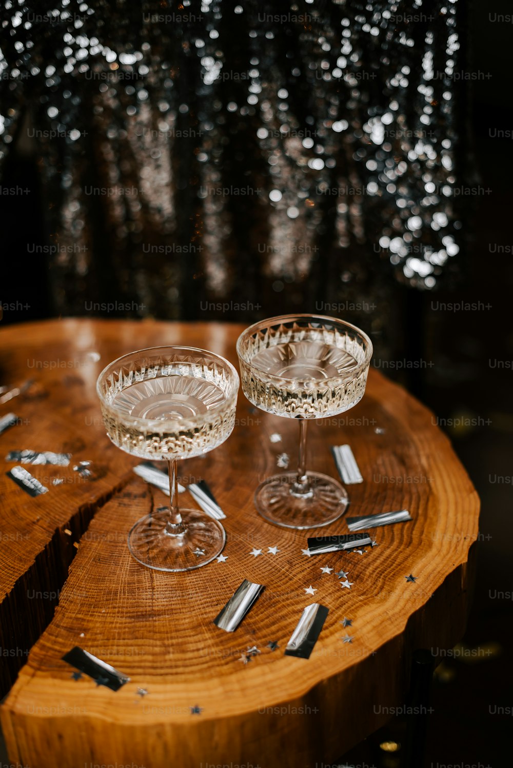 due bicchieri di vino seduti sopra un tavolo di legno