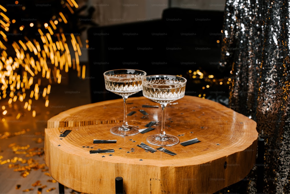 two glasses of wine sitting on a wooden table