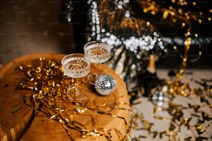a wooden table topped with glasses and confetti