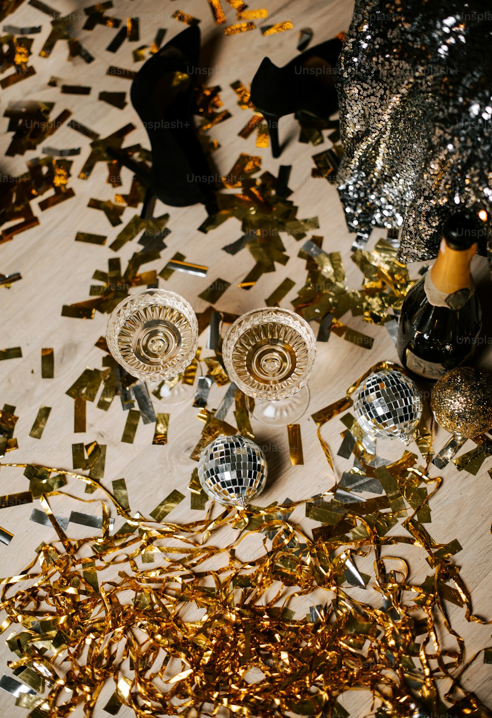 a table topped with champagne glasses and confetti