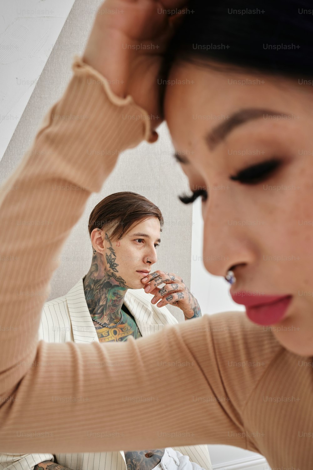 a woman looking at her reflection in a mirror