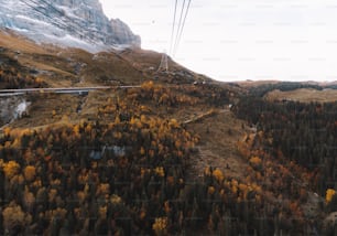 a scenic view of a mountain with a ski lift in the background