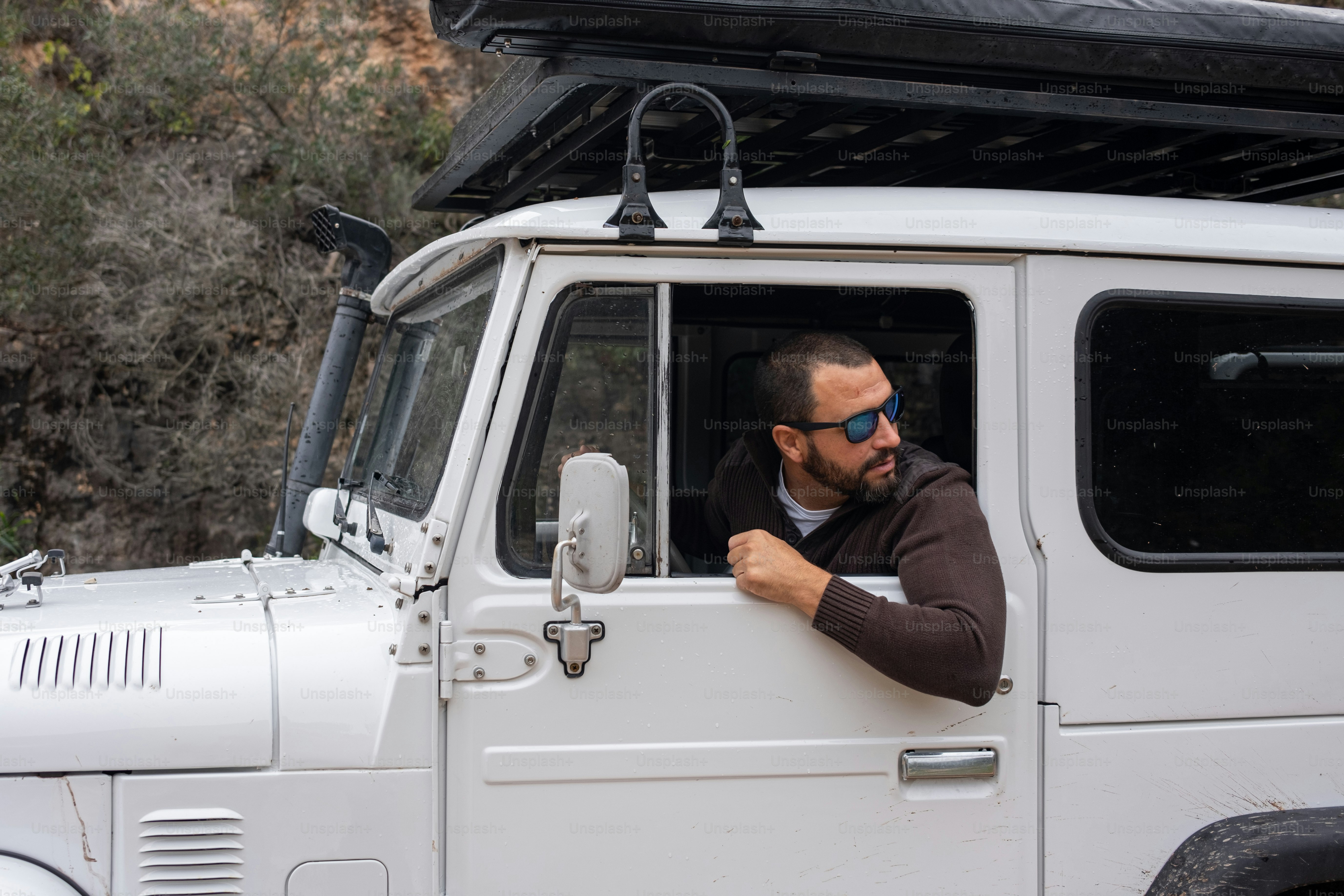 a man sitting in the driver's seat of a white truck