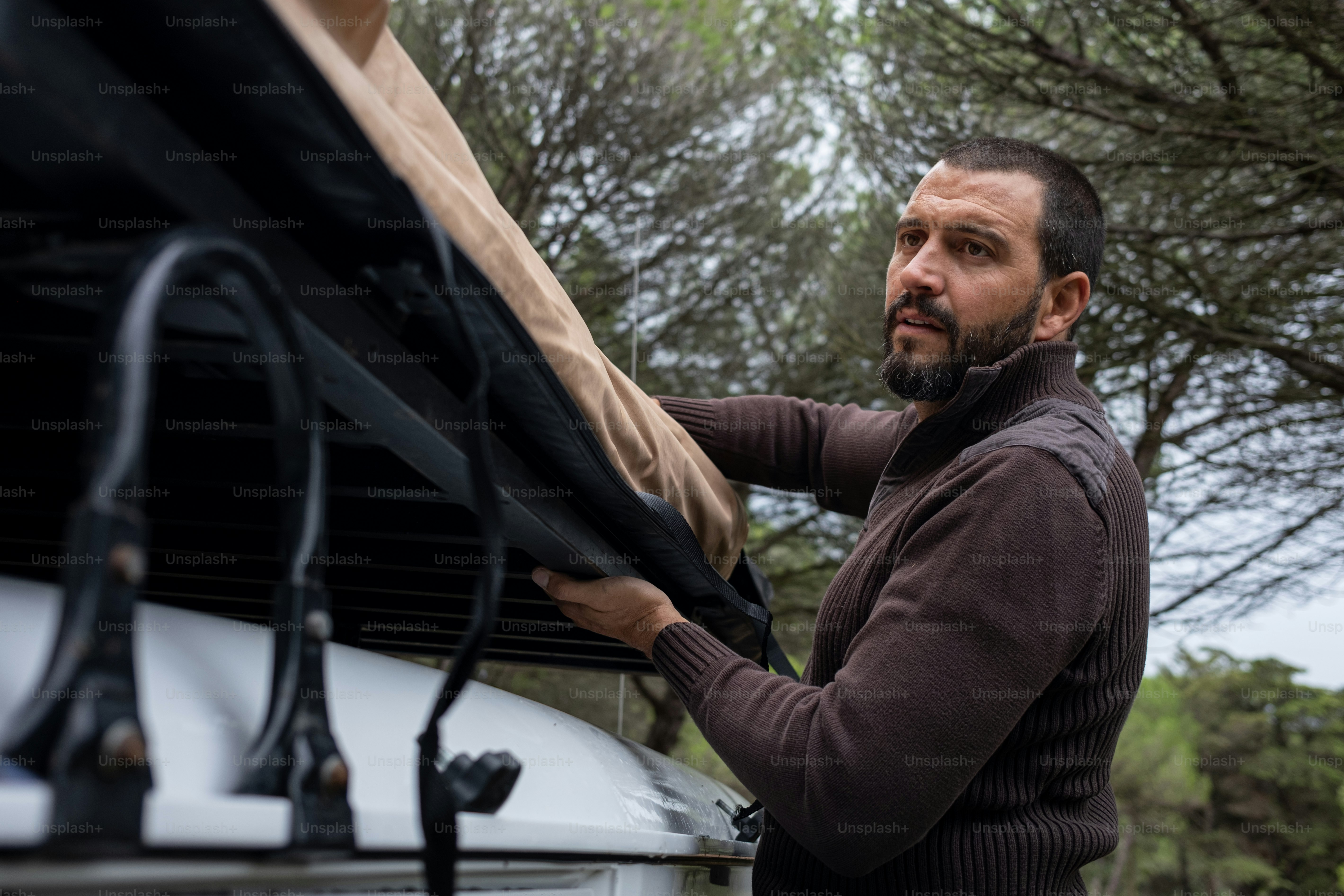 a man standing next to a white truck