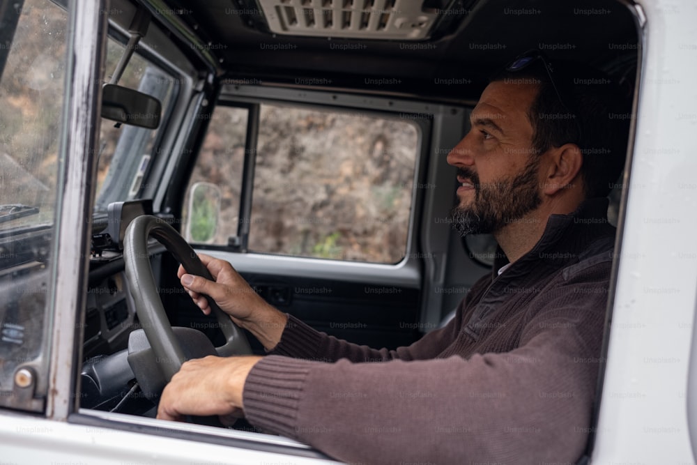 a man sitting in the driver's seat of a truck