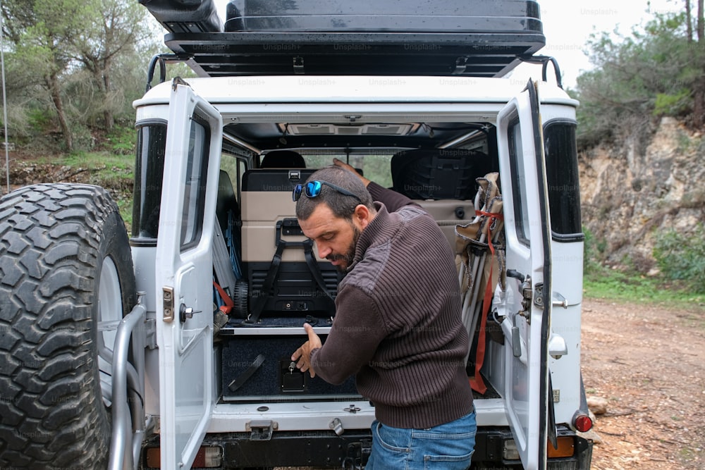 a man standing in the back of a white truck