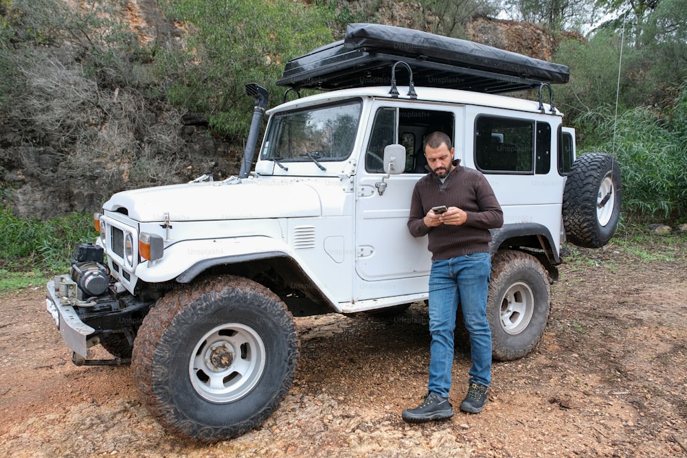 a man standing in front of a white truck