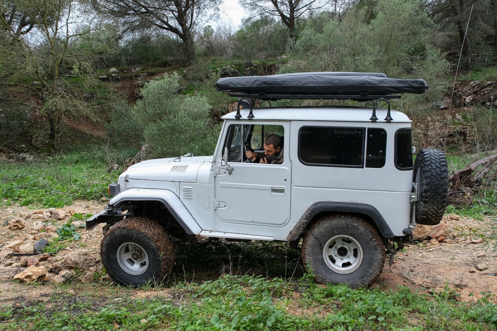 a white jeep with a black top and a black roof
