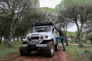 a man climbing up the side of a white truck