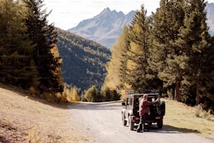 a jeep driving down a road in the mountains
