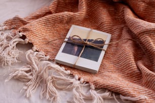 a book wrapped in a blanket on a bed