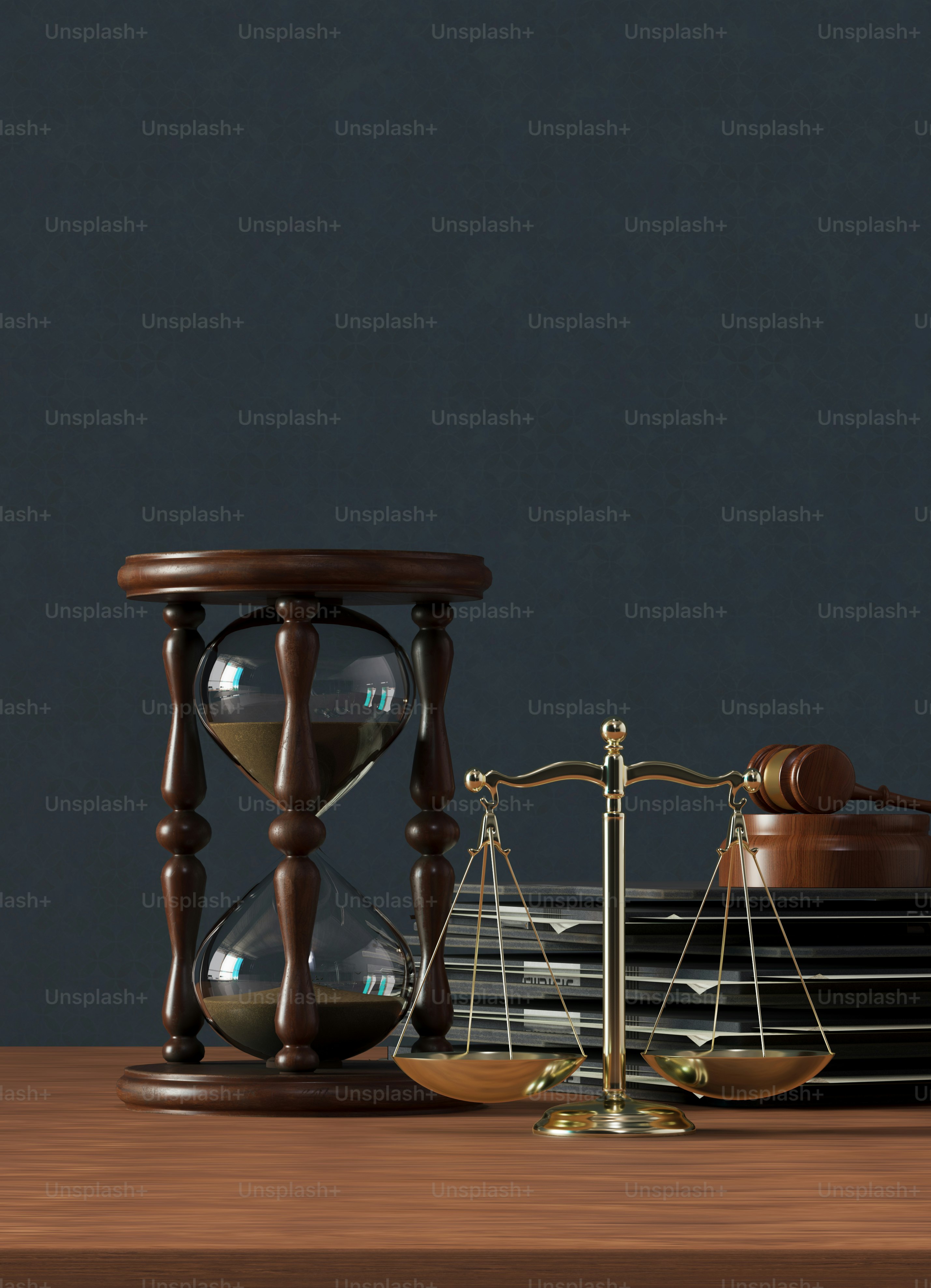 a wooden table topped with an hourglass and a scale