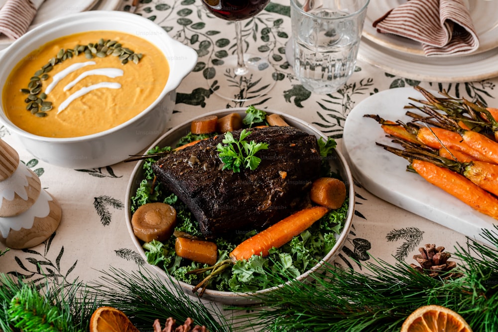 a table topped with plates of food and a bowl of soup