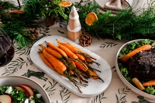 a table topped with plates of food and bowls of vegetables