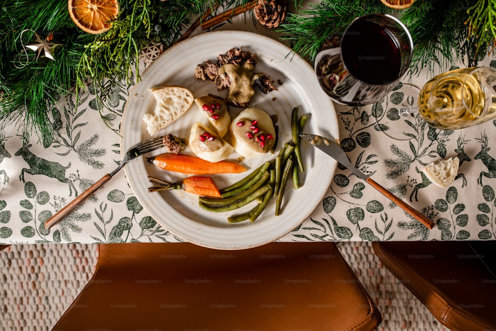 a white plate topped with food next to a glass of wine