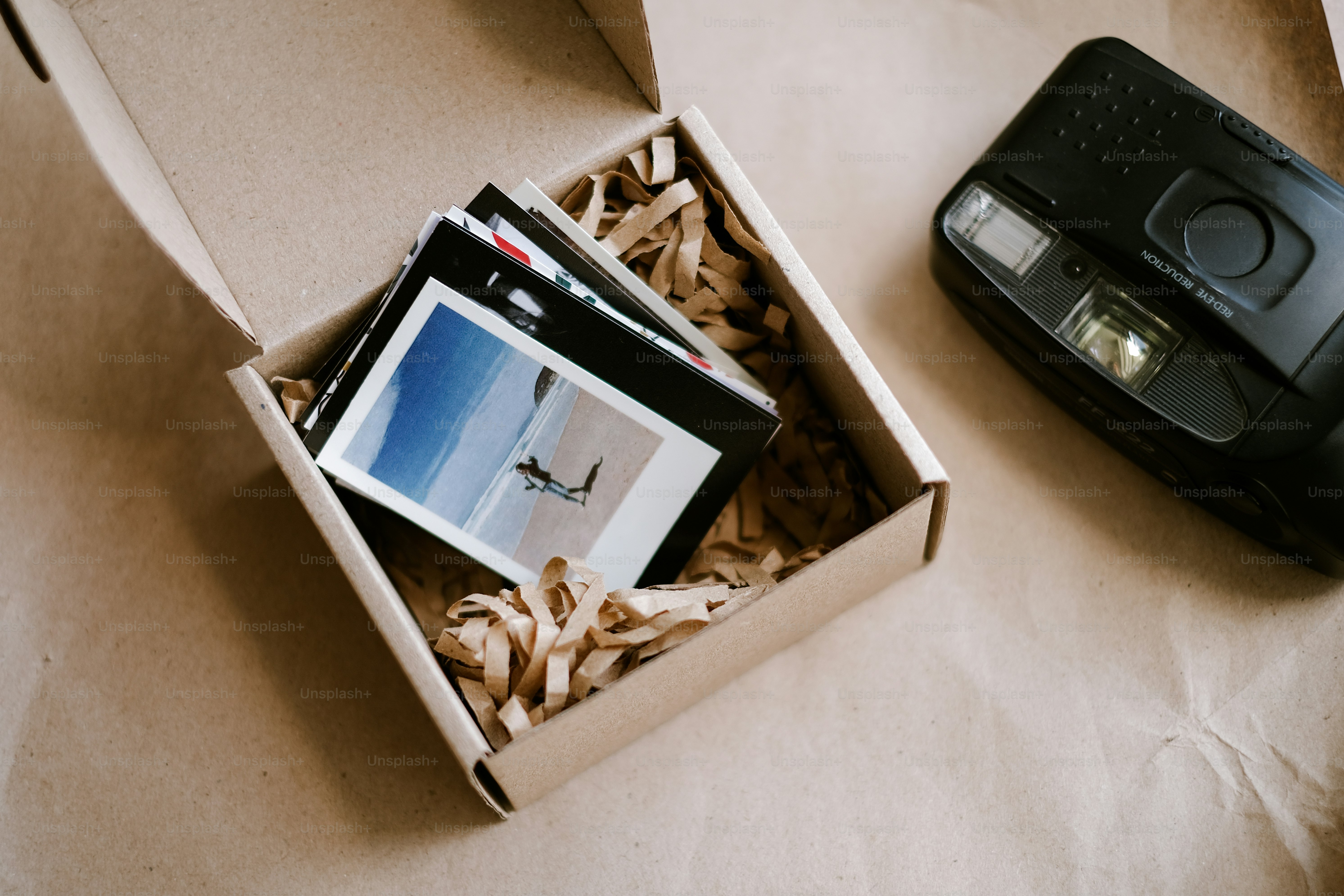 an open box containing a camera and a picture