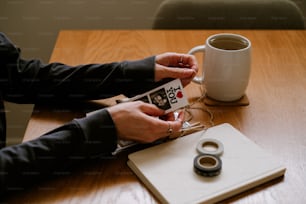 a person sitting at a table with a cup of coffee