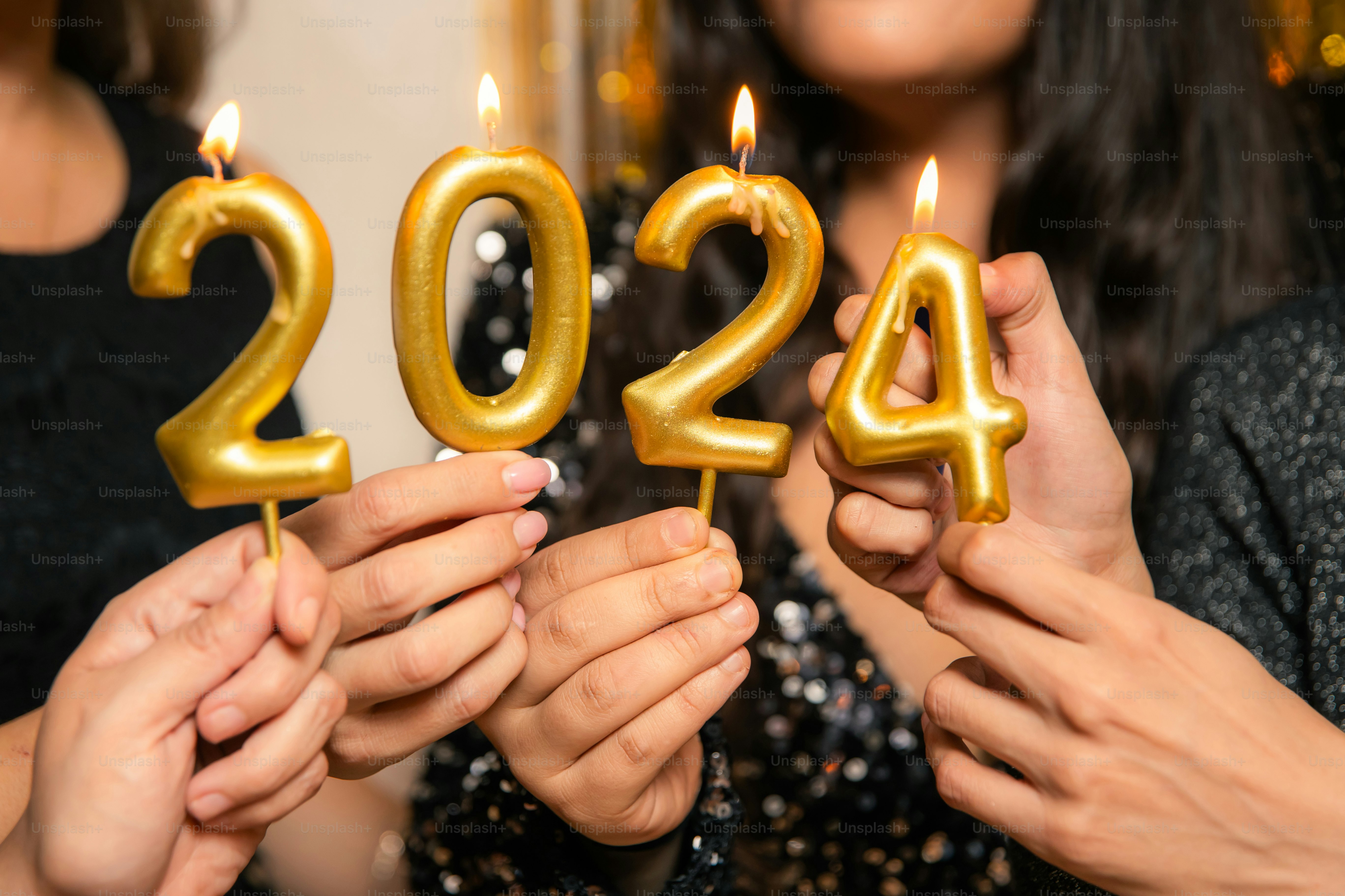 um grupo de pessoas segurando velas em forma de números