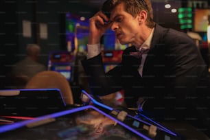 a man in a tuxedo playing a video game
