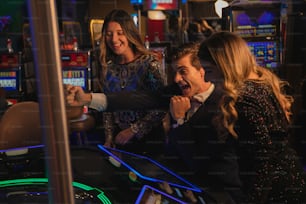 a group of people playing a game of slot machines