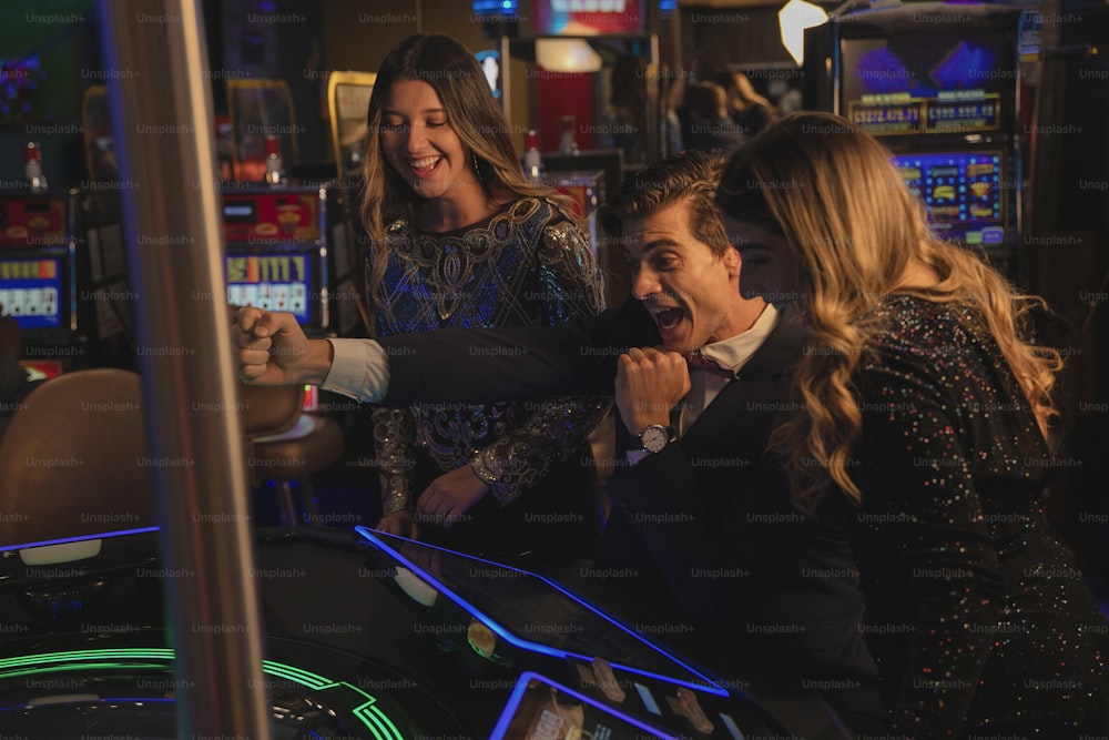 a group of people playing a game of slot machines