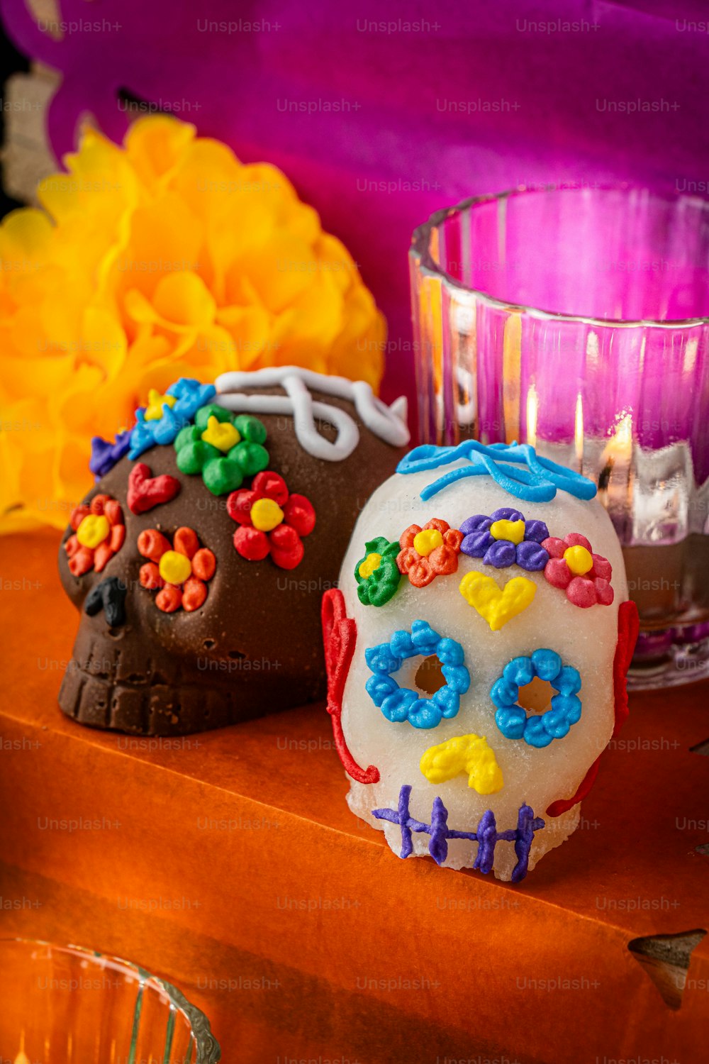 a couple of sugar skulls sitting on top of a table