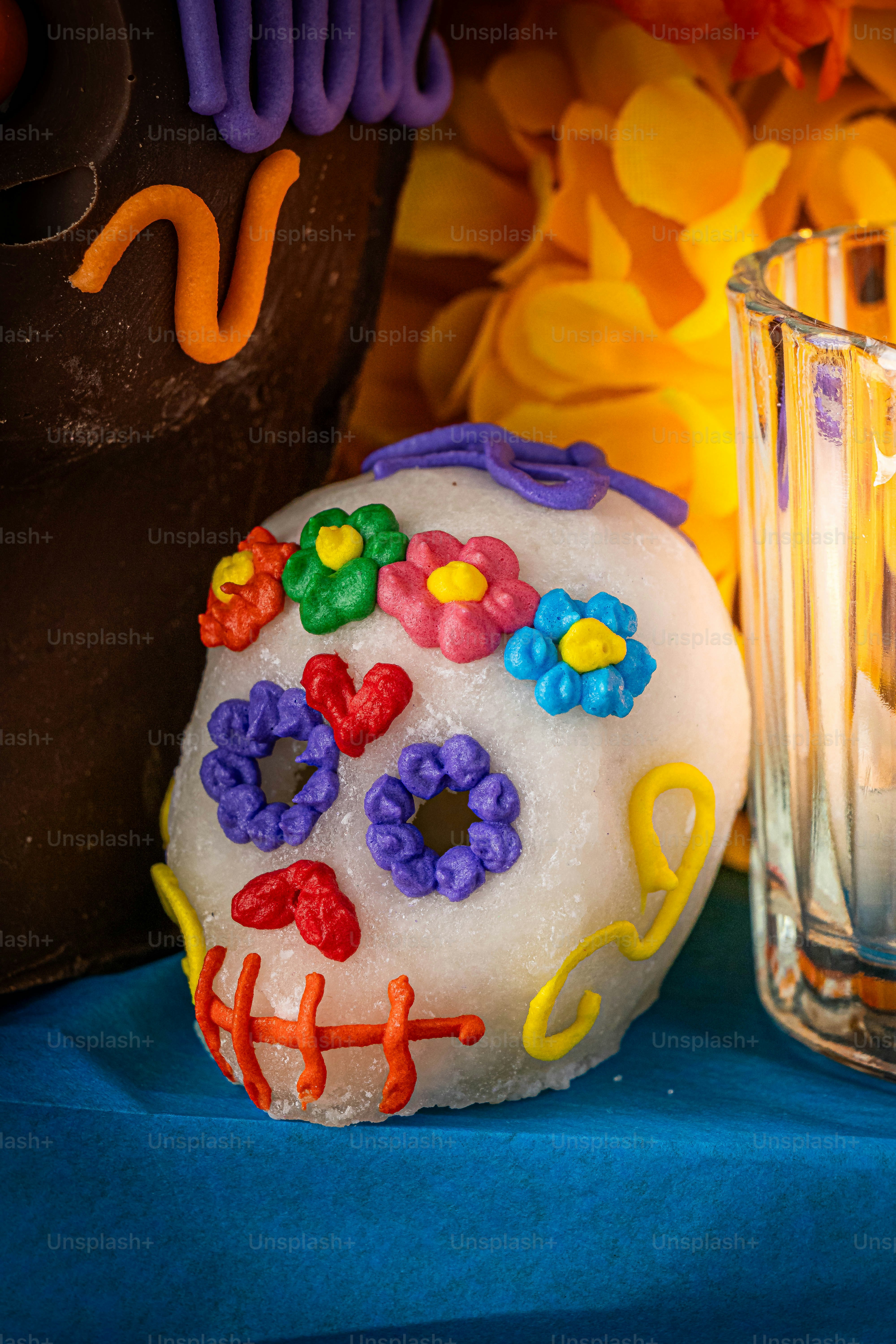 a decorated doughnut next to a glass of water
