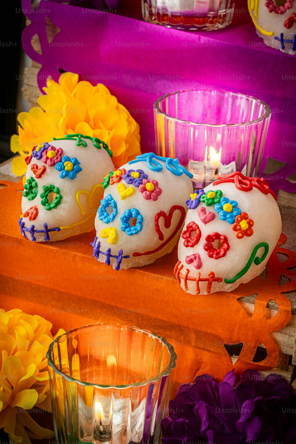 a couple of sugar skulls sitting on top of a table