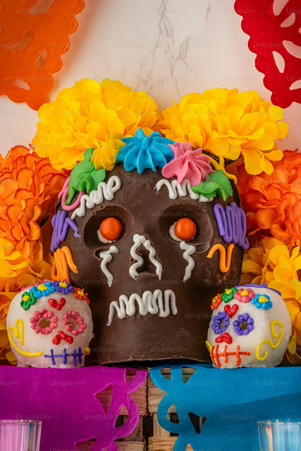 a cake decorated with sugar skulls and flowers