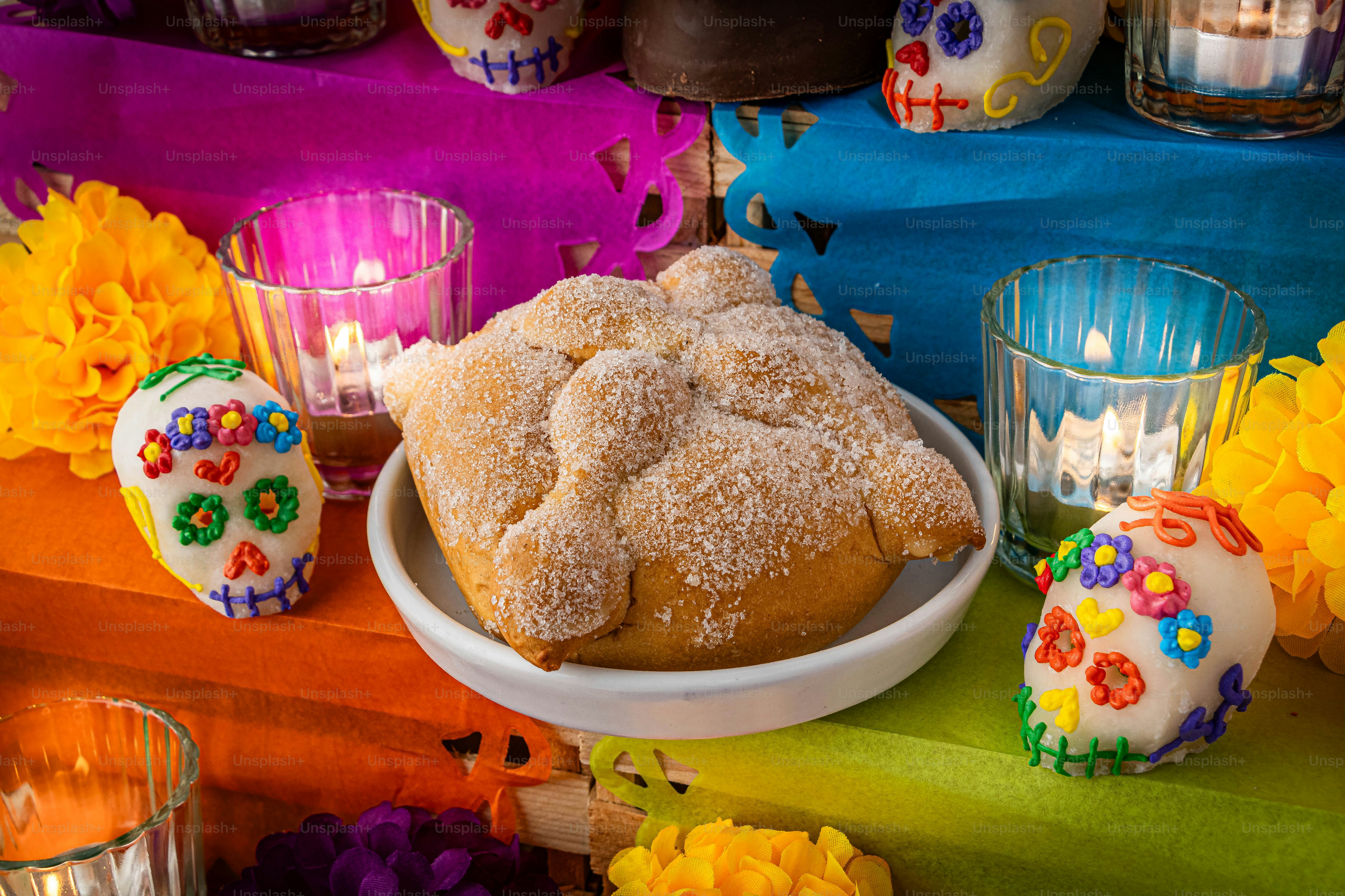 a table topped with a bowl of cake next to candles