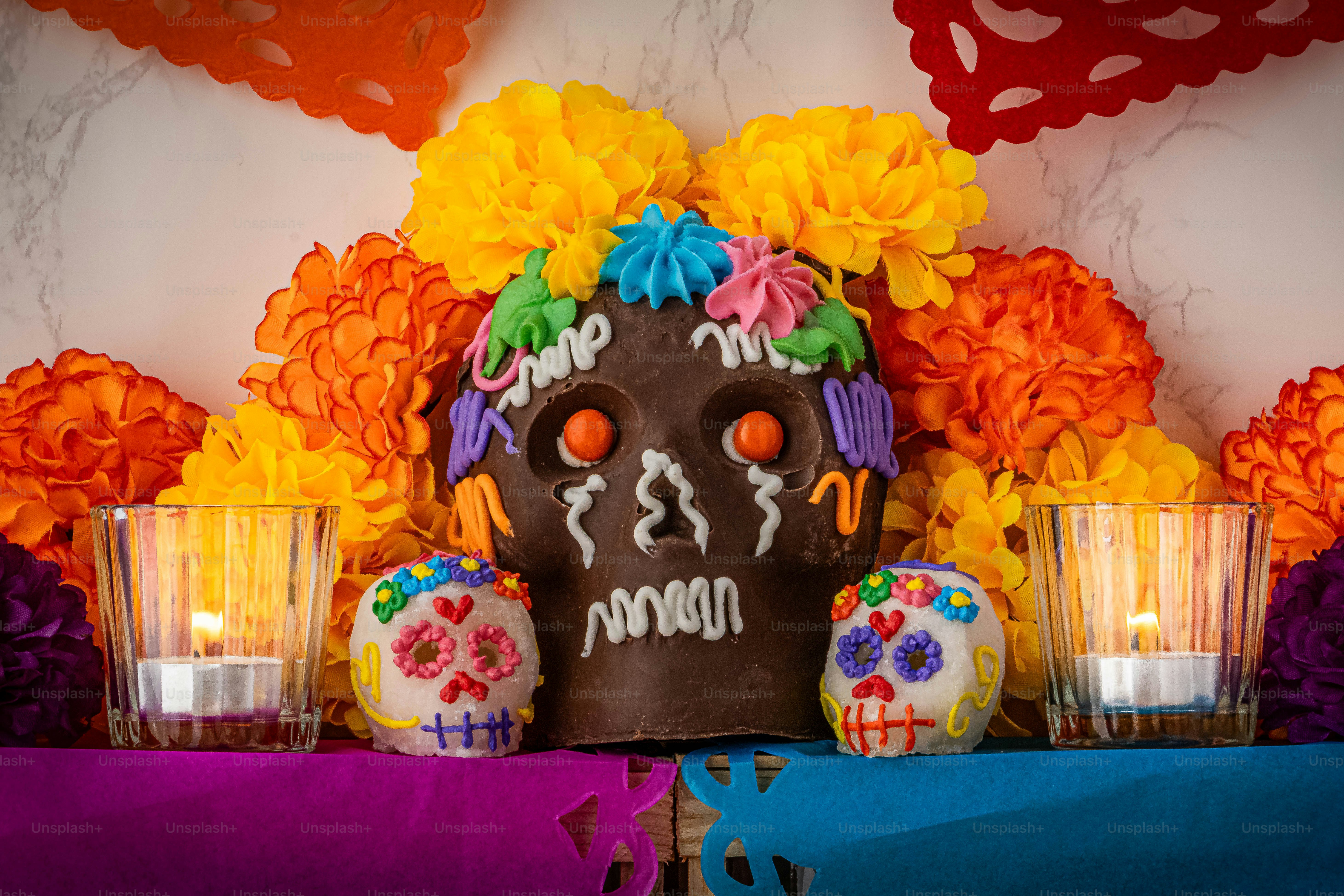 a decorated day of the dead skull with candles