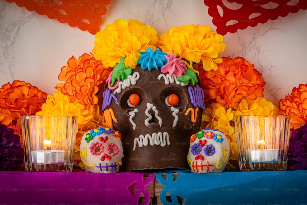 a decorated day of the dead skull with candles