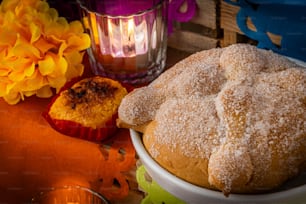 a bowl of powdered sugar next to a candle