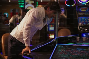 a man in a white shirt and tie leaning over a table