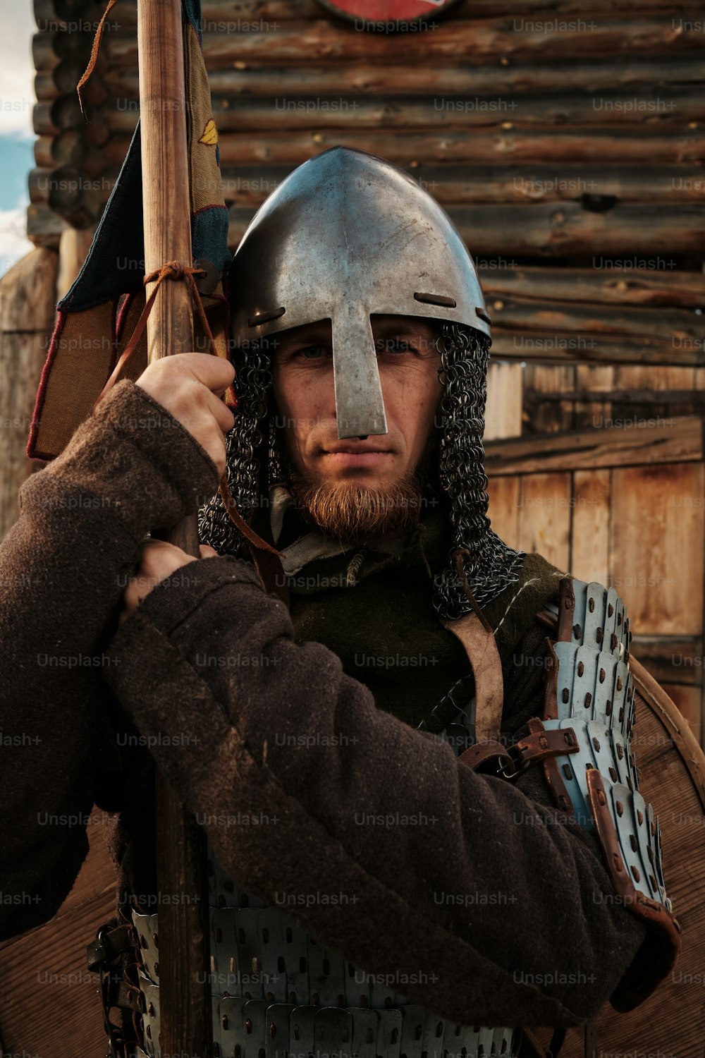 a man in a helmet holding a wooden stick
