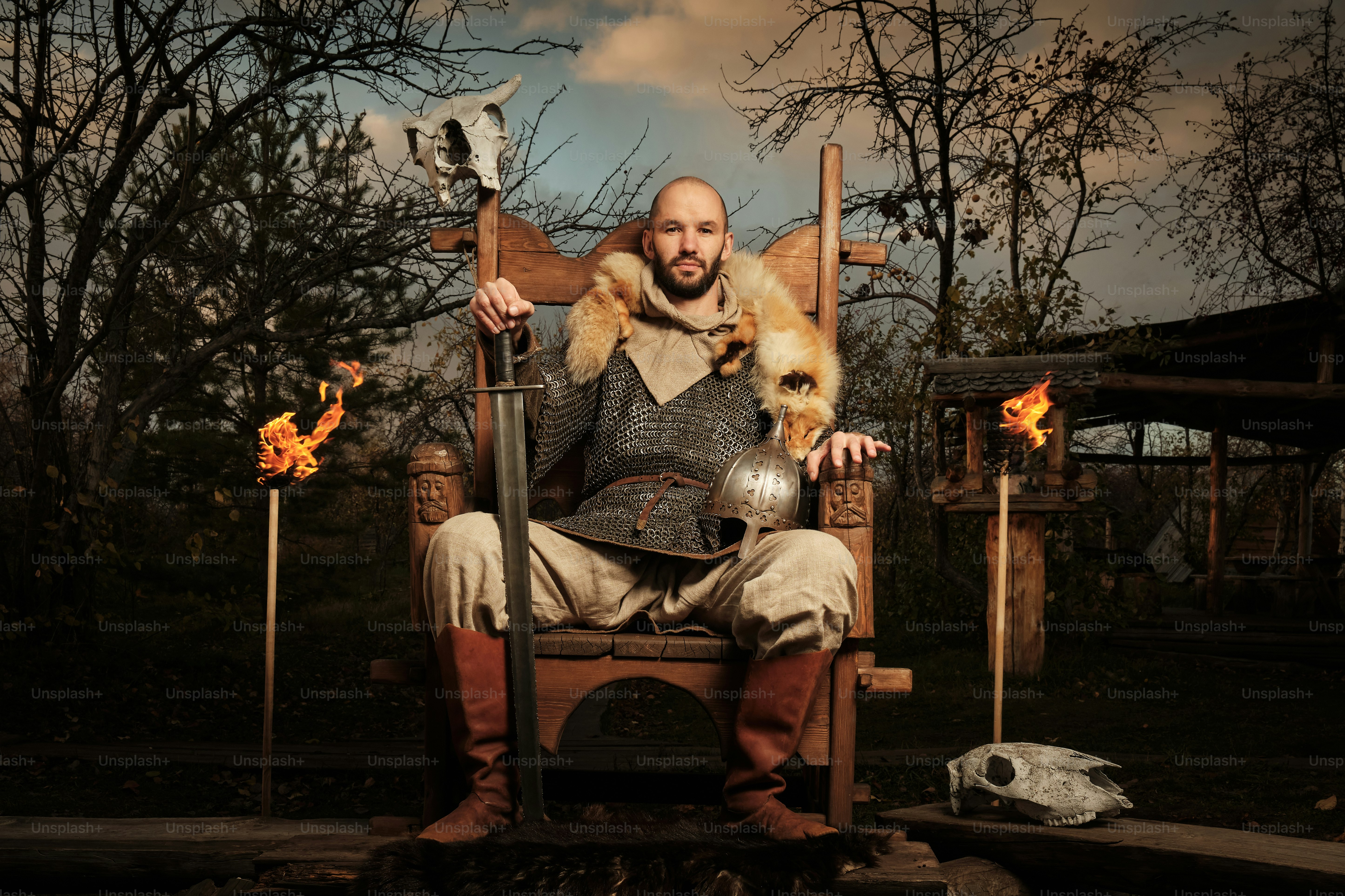 a man sitting in a chair with a dog on his lap