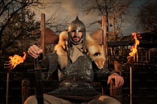 a man in a knight costume sitting in a chair