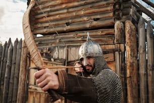 un uomo vestito da cavaliere che tiene in mano arco e frecce