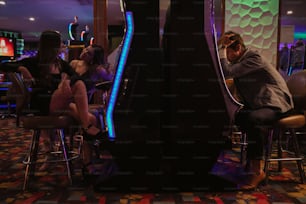 a group of people sitting around a bar