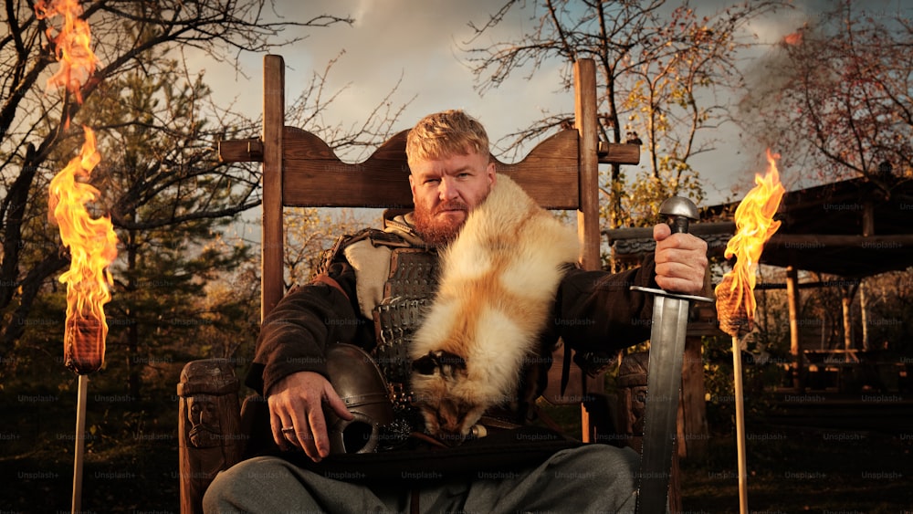 a man sitting in a chair with a cat on his lap