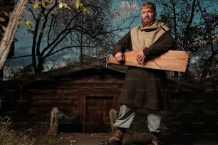 a man holding a piece of wood in his hands