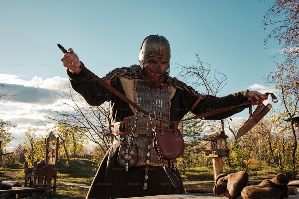 a man dressed in medieval clothing holding a knife