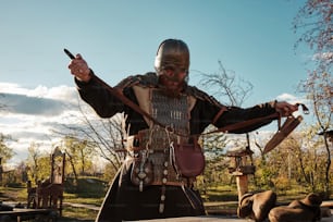 a man dressed in medieval clothing holding a knife