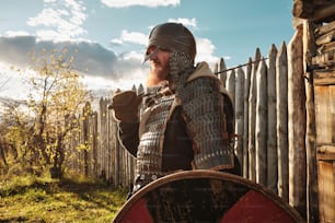 a man dressed in armor holding a sword and shield