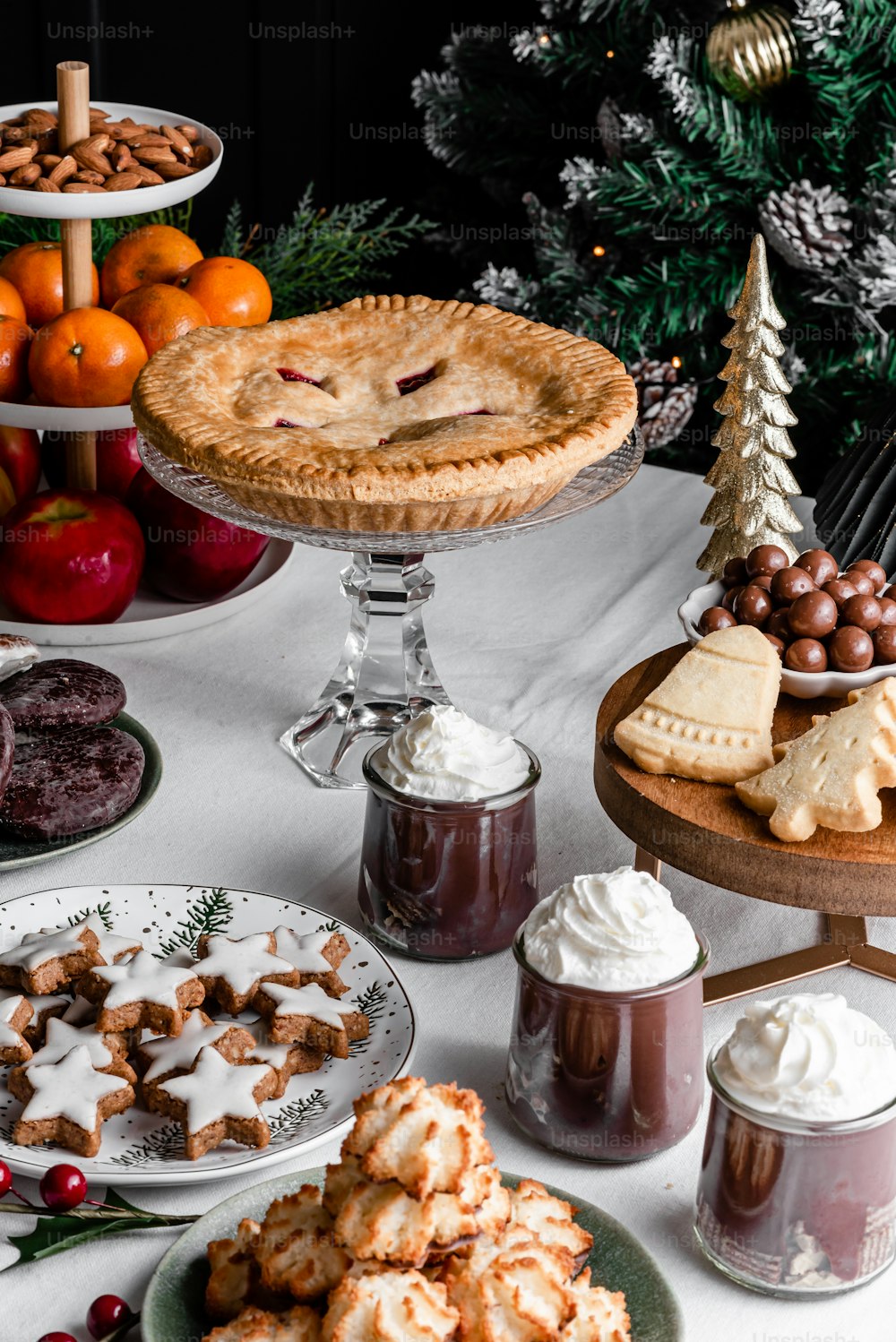 a table topped with pies and other desserts