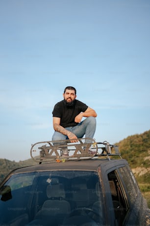 a man sitting on top of a vehicle