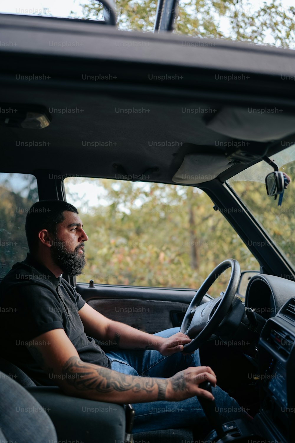 a man sitting in the drivers seat of a truck