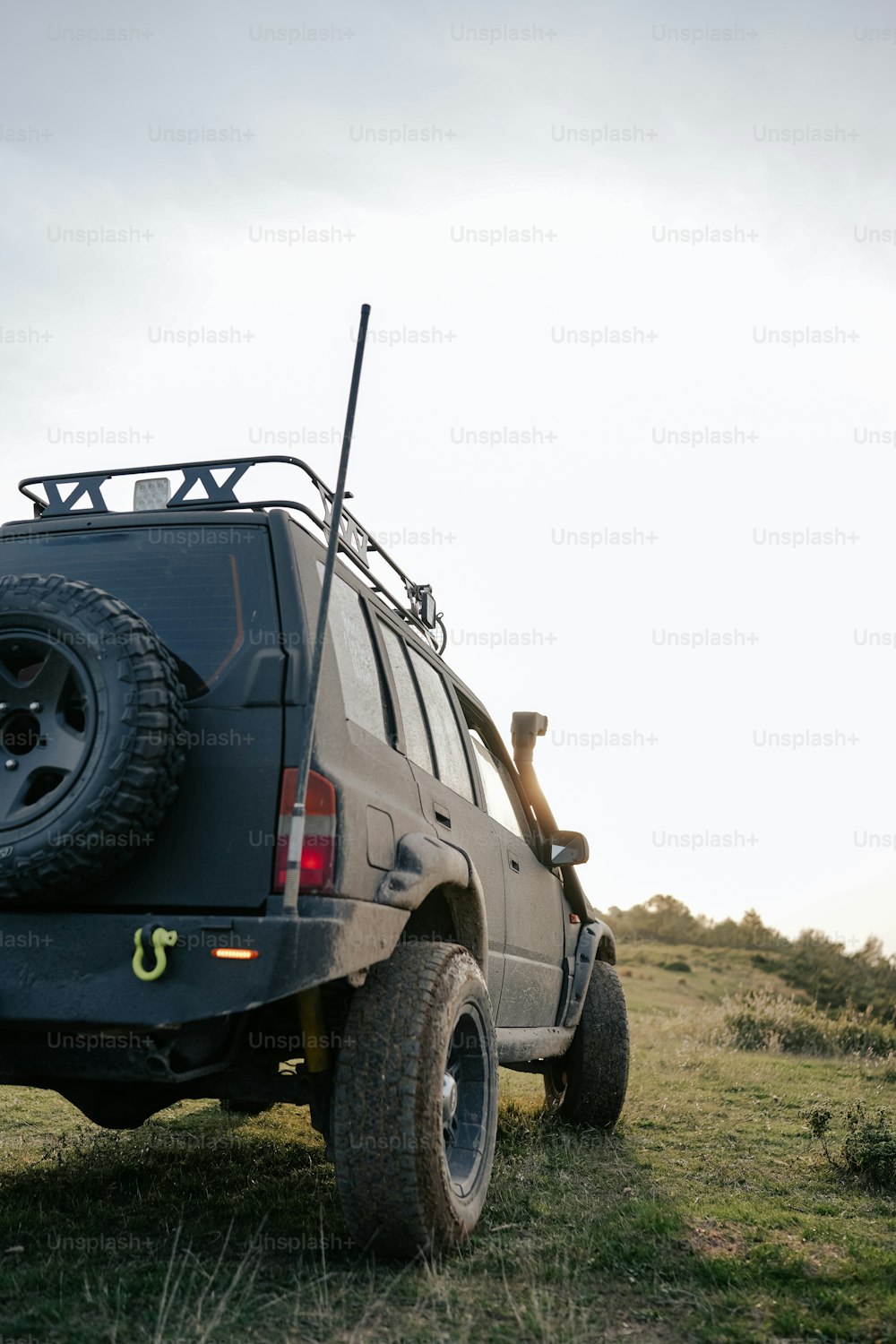 a vehicle parked in a grassy field on a sunny day