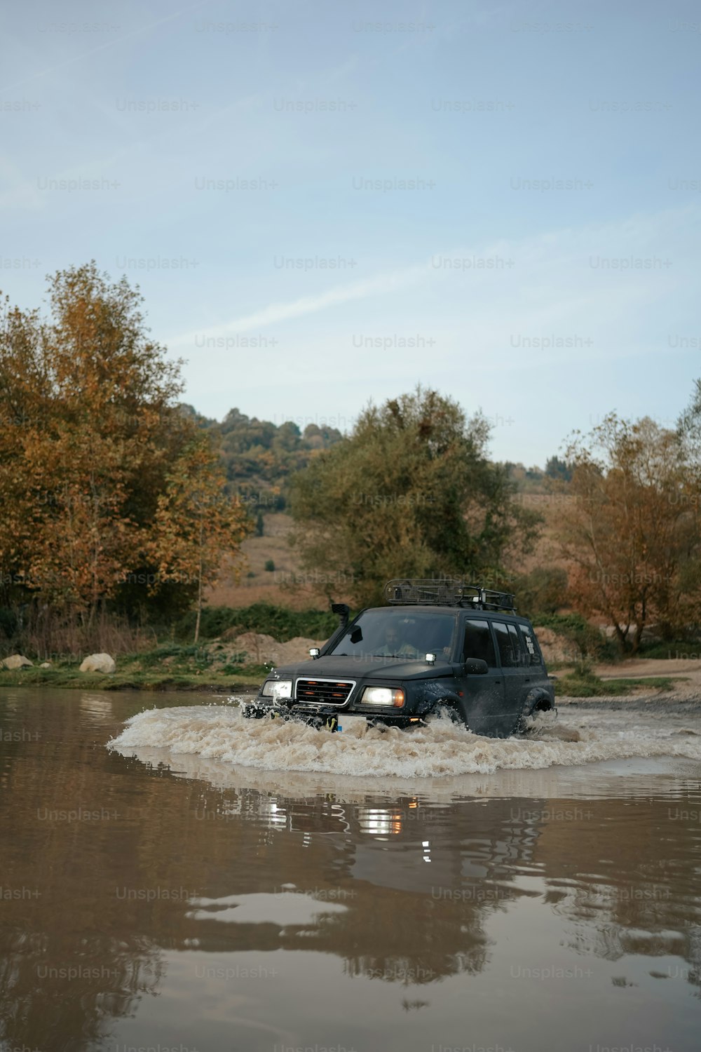 a vehicle is driving through a flooded area